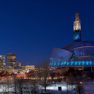 The Winnipeg Human Rights Museum with a northern lights glowing interior. Located in Winnipeg Manitoba.