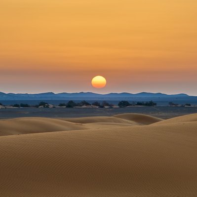 Moroccan landscape photograph featuring a sunrise over the dunes near Merzouga. 