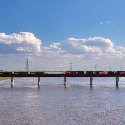 A train passes over the full Winnipeg floodway, during a spring flood.