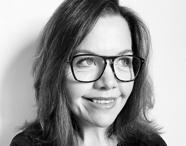 A black and white photograph of food photographer Amelia Johnson at her Dorset Studio