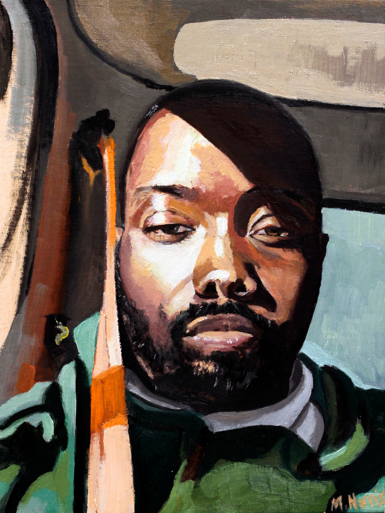 black man wearing a green jacket in truck with the afternoon sun on his face