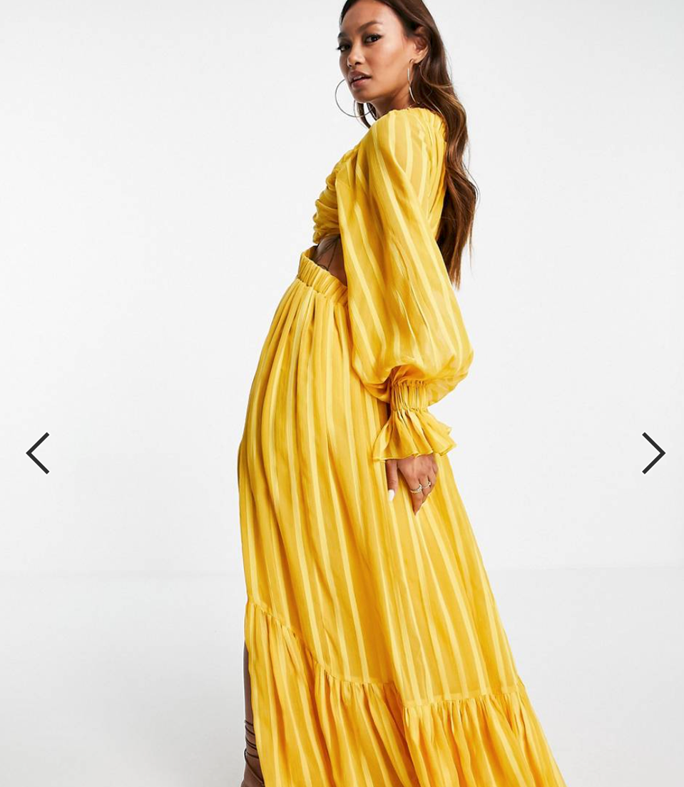 lady posing in long yellow dress with belt