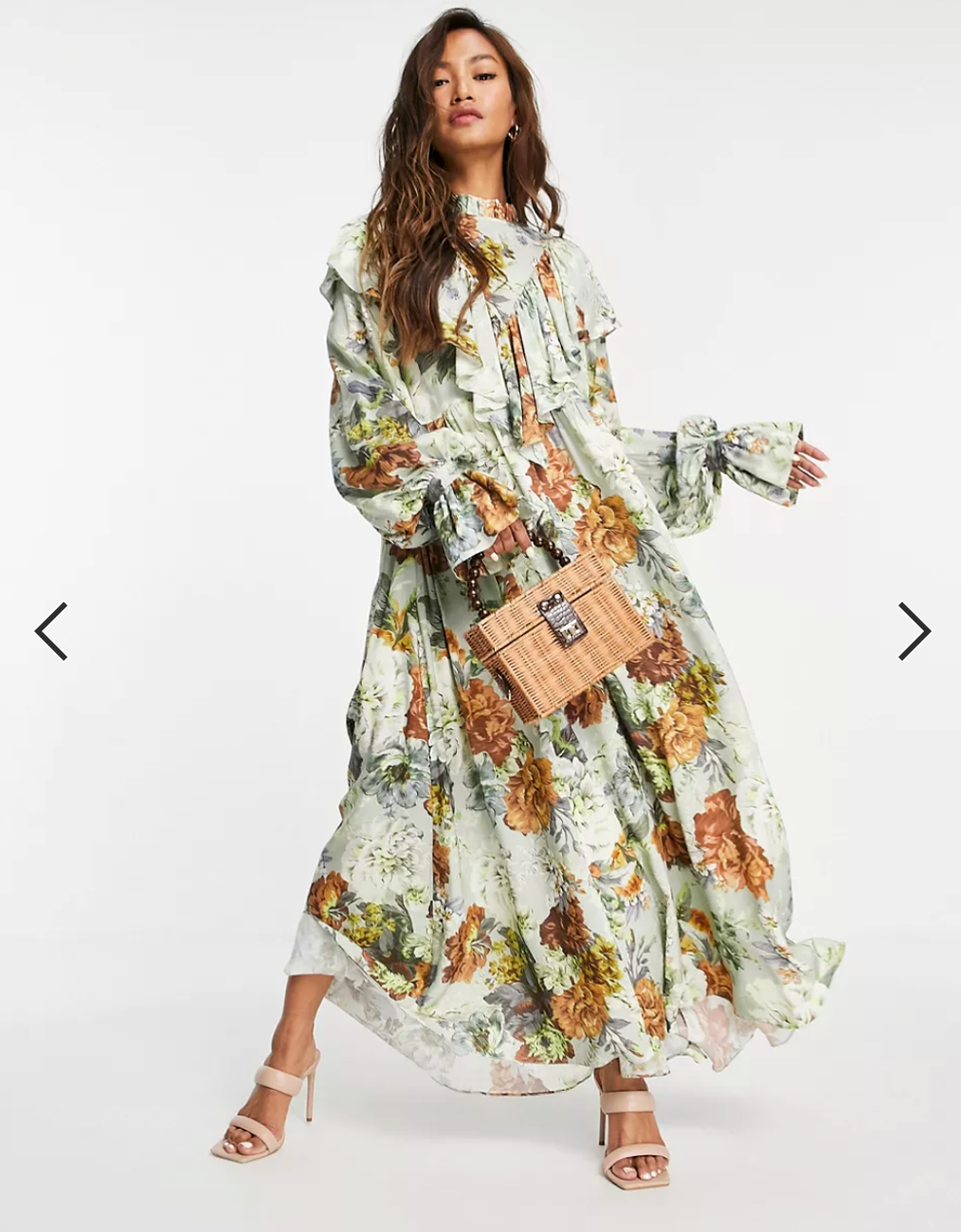 woman posing in long floral dress