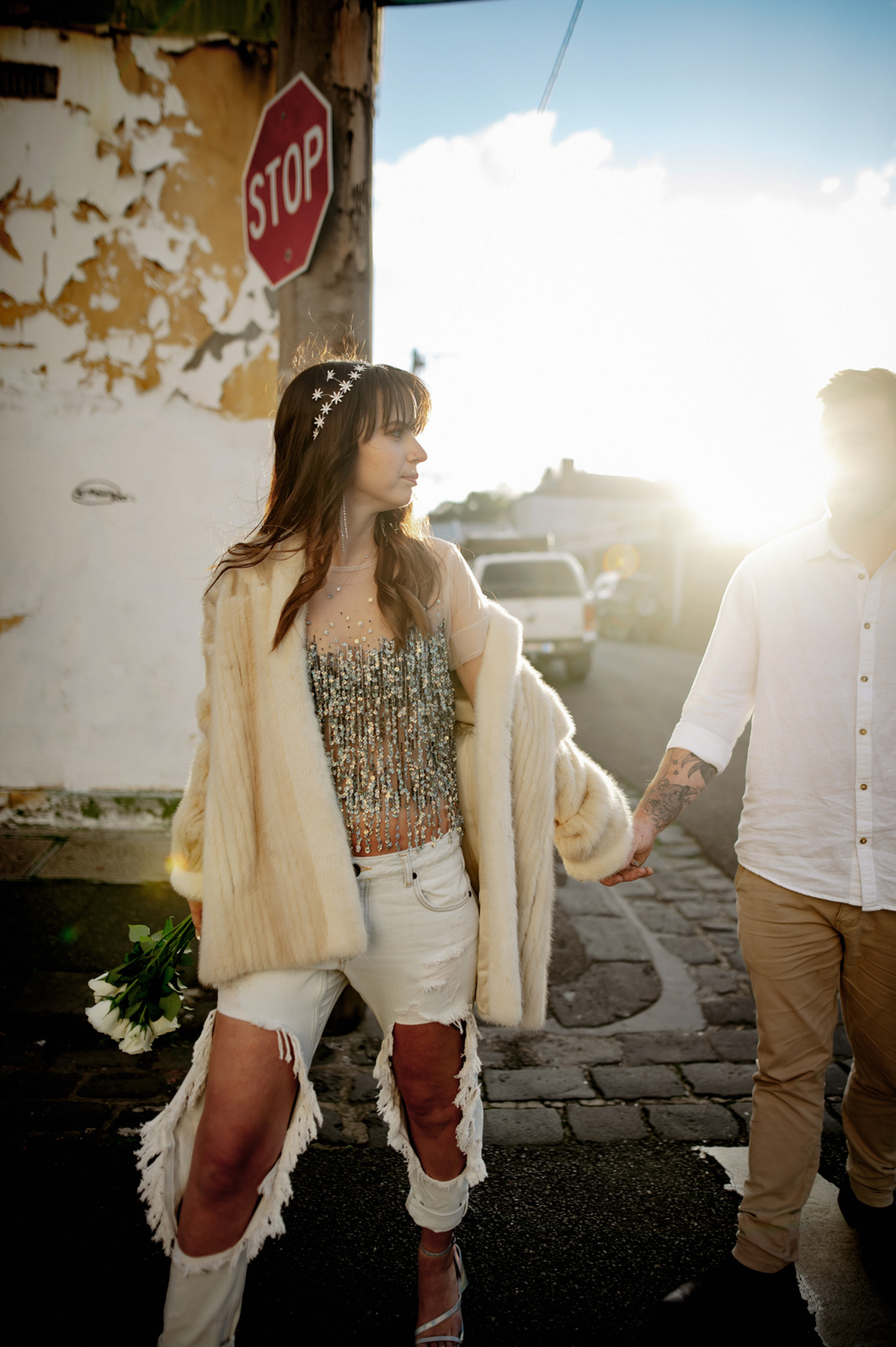 Women leading man in a urban scape on sunset