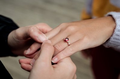 two hands close up displaying an engagement ring 