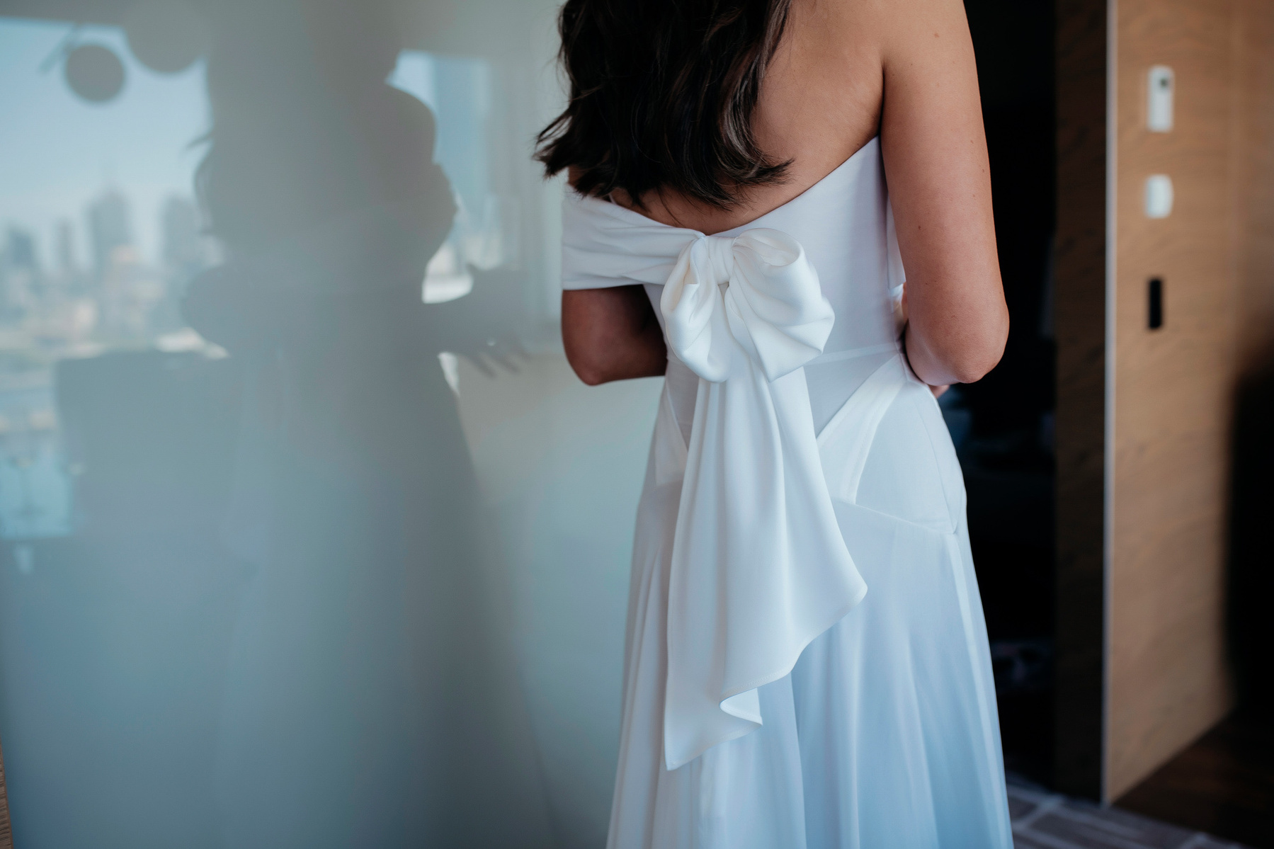 back of a white dress with a bow