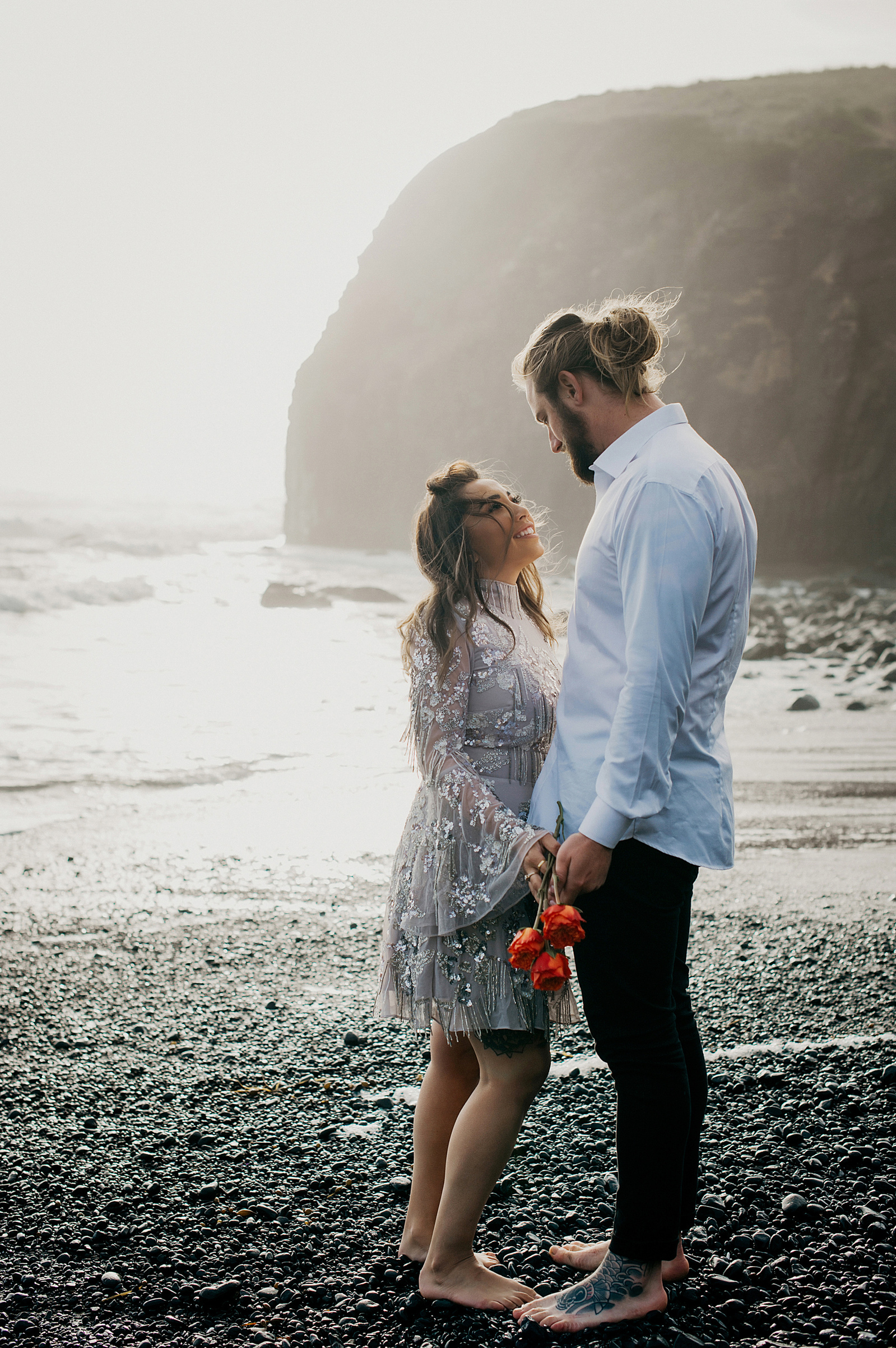 Couple holding hands looking at each other 
