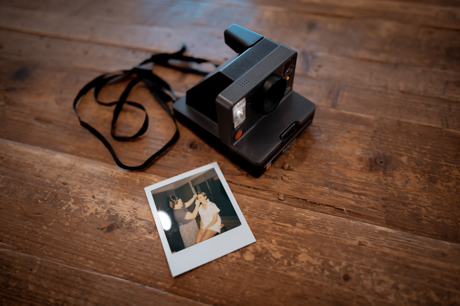 old camera with a polaroid picture next to it 