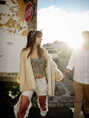 Lady looking back at man in ally way with sunset behind them