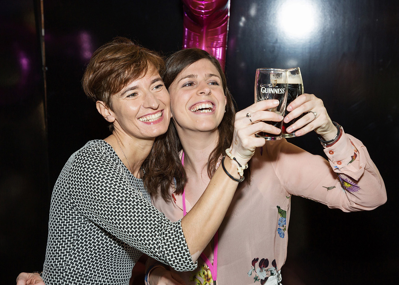 Corporate team building event in Guinness Storehouse Dublin. Professional event photo of female attendees with a pint of Guinness. Event photographer Dublin