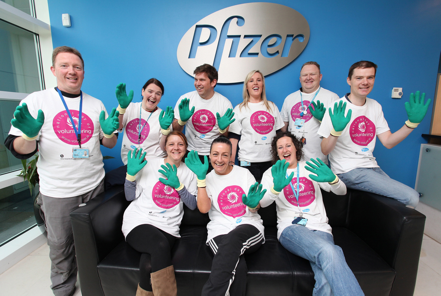 Large group photo of Pfizer corporate employees wearing branded t-shirts to celebrate National Day of Volunteering, professional event photographer Dublin