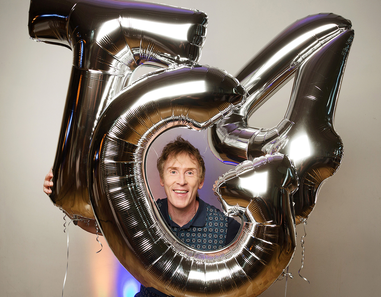 Irish television presenter Hector Ó hEochagáin pictured looking through TG4 balloons at Press PR photocall event to launch TG4 programmes for new season. Images syndicated onsite to national media, professional photographer Dublin