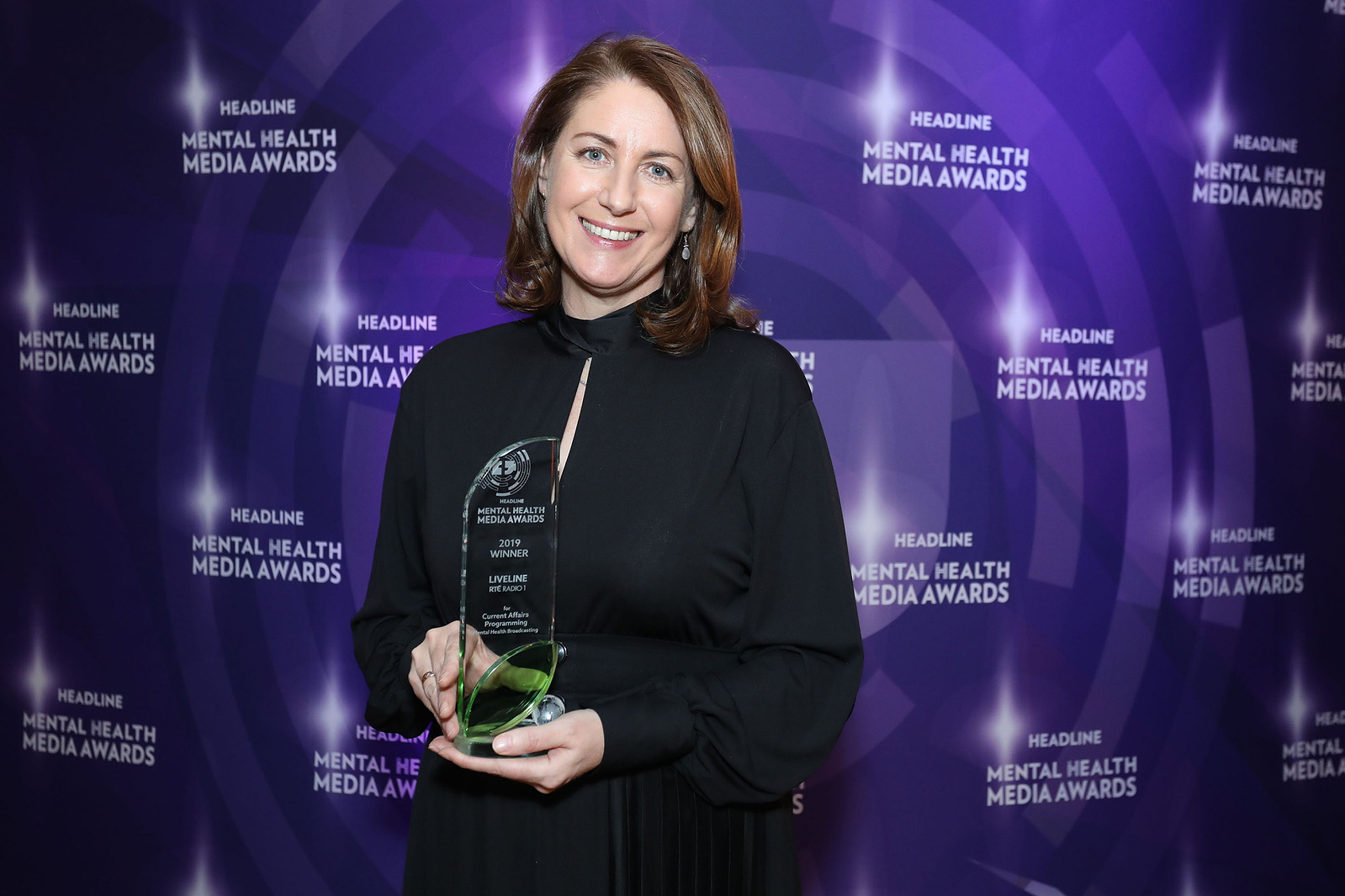 Female award winner presentation photo at Headline Mental Health Media Awards in Dublin. Professional event photographer www.eventimage.ie