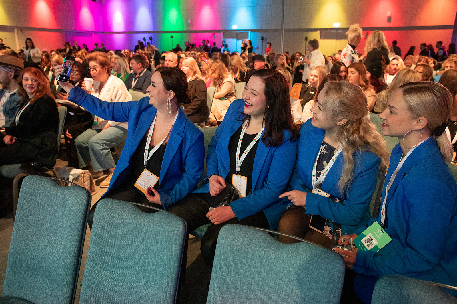 Live event photo of delegates in audience at a summit in Dublin taking a selfie. Taken by a professional event photographer www.eventimage.ie 