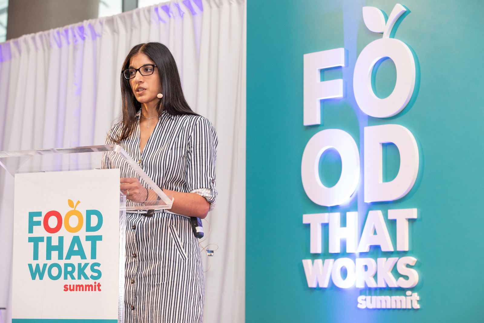 Female speaker at podium Food That Works Summit exhibition and conference photographer Dublin 