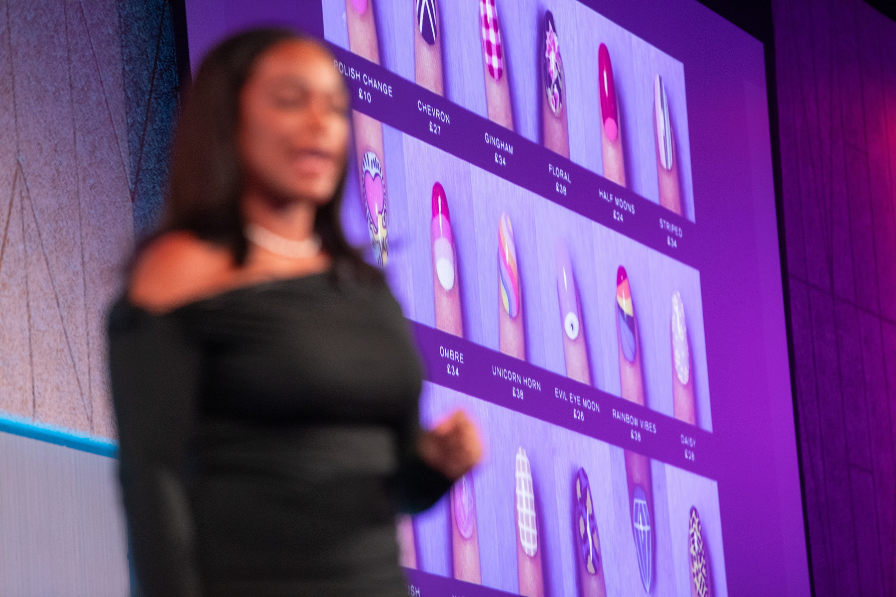 Live Event photography Dubin, female speaker on stage at Salon Owners Summit 2024 in Dublin Royal Convention Centre