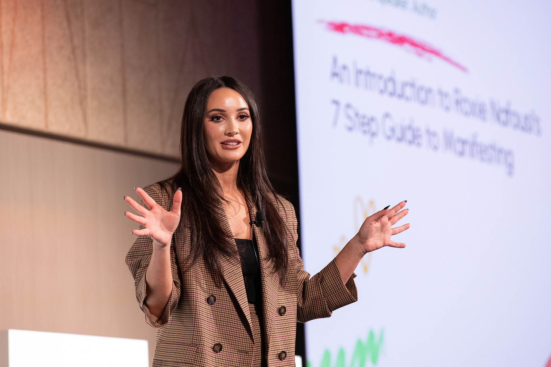 Live Event photography Dubin, female speaker on stage at Salon Owners Summit 2023 in Dublin Royal Convention Centre