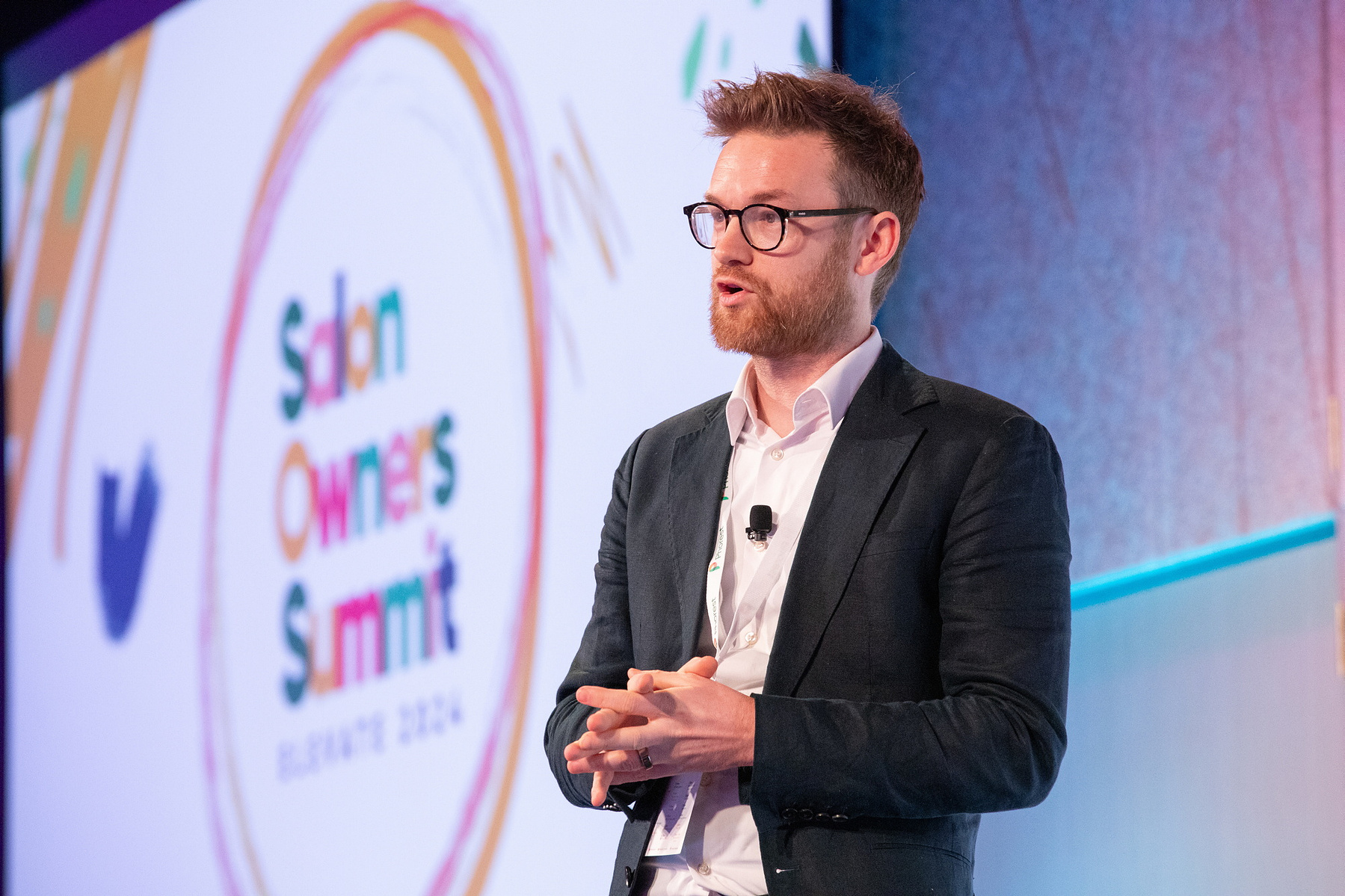 Live Event photography Dubin, male speaker on stage at Salon Owners Summit 2024 in Dublin Royal Convention Centre