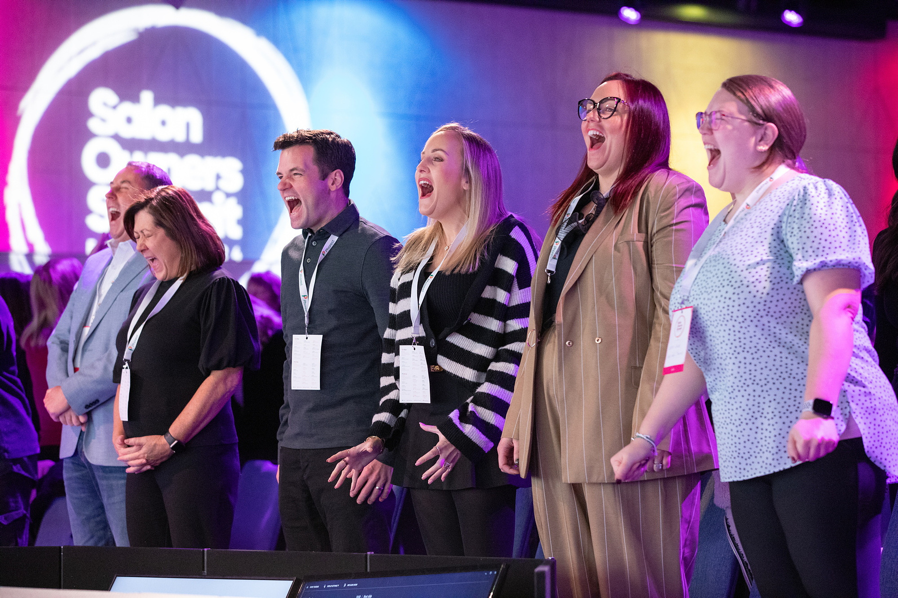 Event attendees on stage at Salon Owners Summit 2024 in Dublin Royal Convention Centre. Professional event photographer Dublin