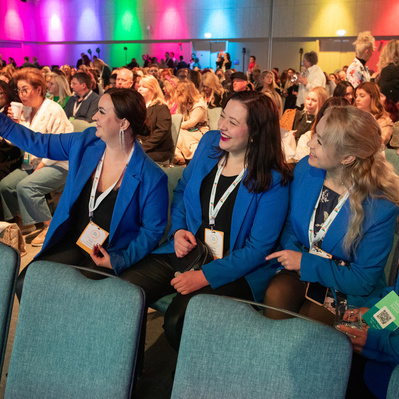 Live event photo of delegates in audience taking a selfie at a summit in Dublin. Taken by a professional event photographer www.eventimage.ie 