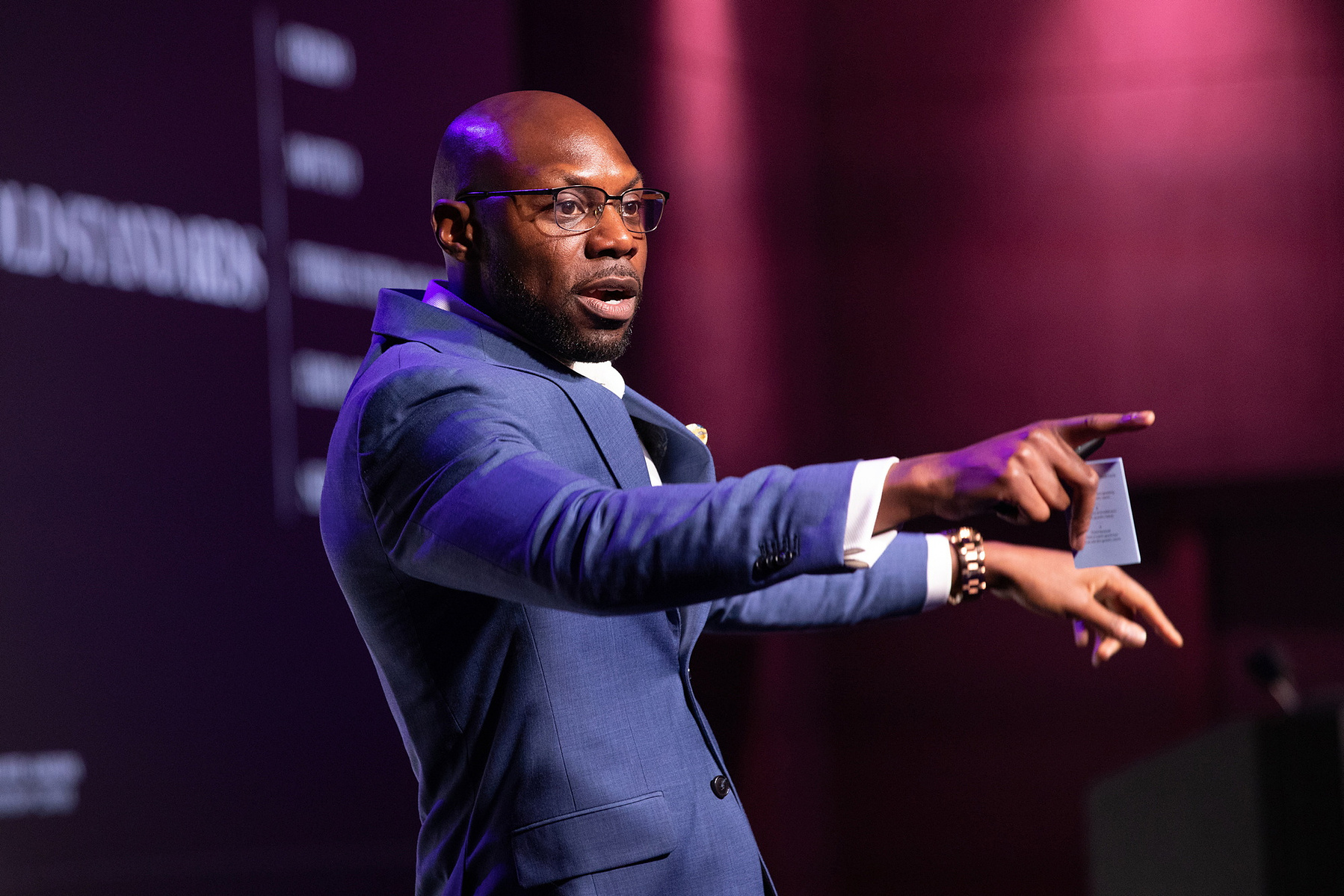 Professional Event photographer Dubin, lively image of speaker on stage at Salon Owners Summit 2023 in Dublin Royal Convention Centre