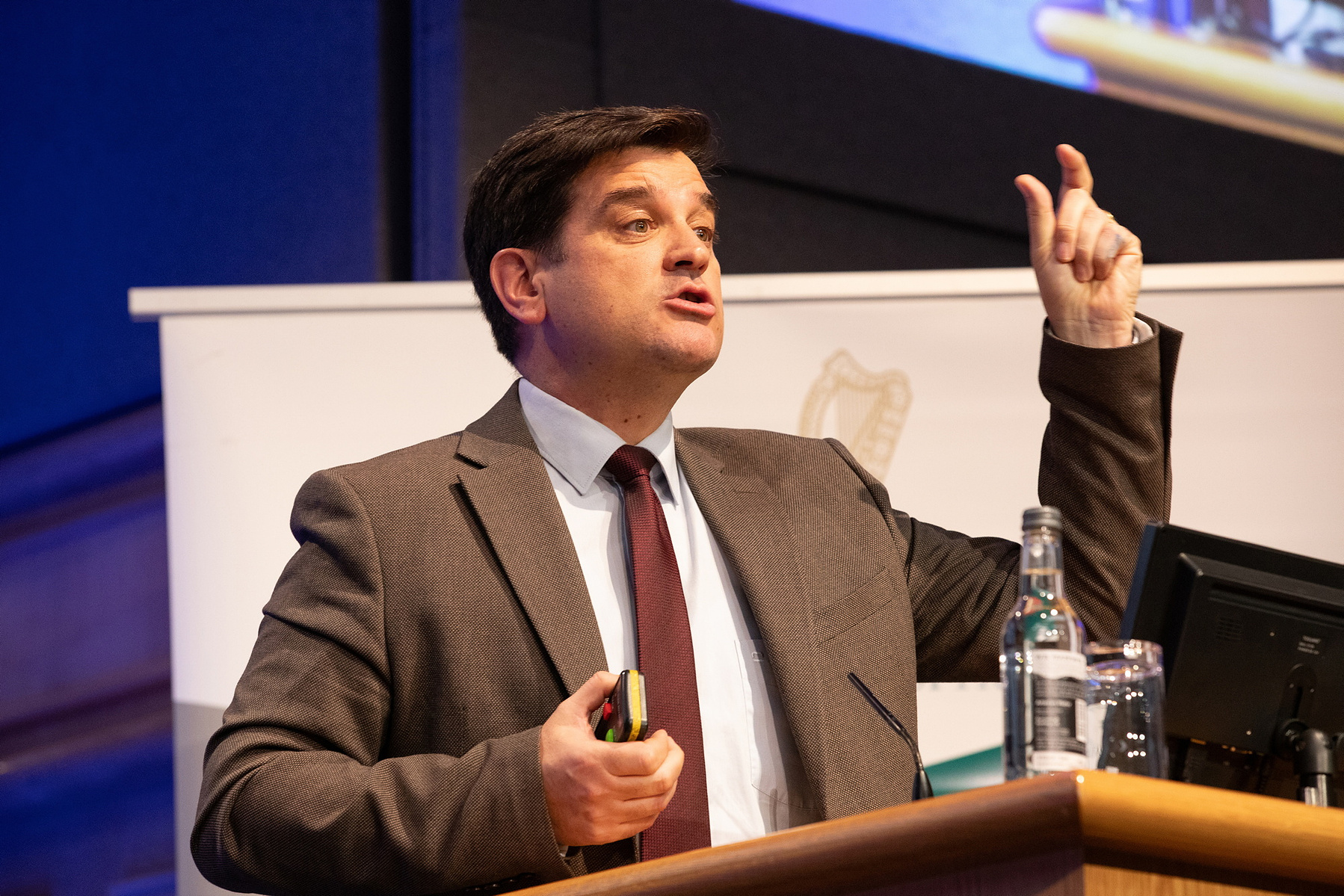 Conference event photo of a male speaker at The Health and Social Care Conference in Dublin Castle.  Corporate Event Photographer Dublin 