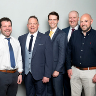 Corporate social event group photo of co-workers against a grey studio background. Photo printed onsite at the event www.eventimage.ie