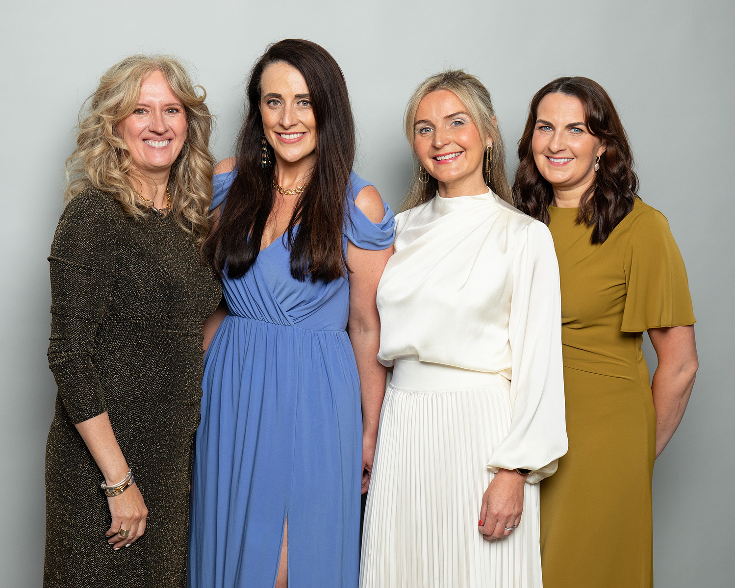 Corporate social event group photo of co-workers against a grey studio background. Photo printed onsite at the event www.eventimage.ie