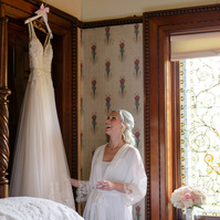 Belhurst Castle bride looking at her dress - Geneva NY