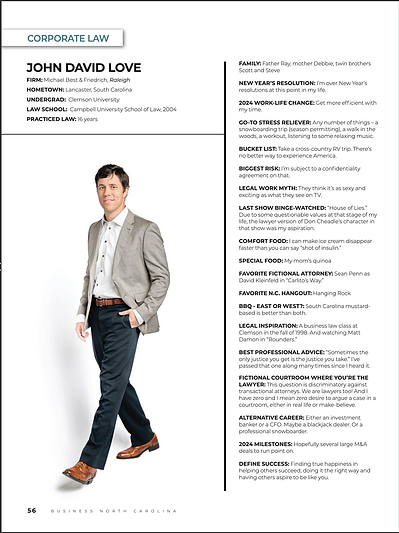 Business North Carolina - Legal Elite Lawyer man in a suit walking forward, staring into the camera with a slight smile.