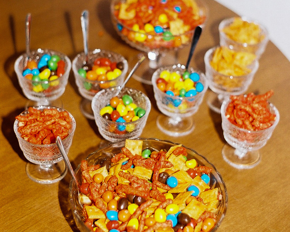 Bright flash photography on bowls of snacks on a wooden table