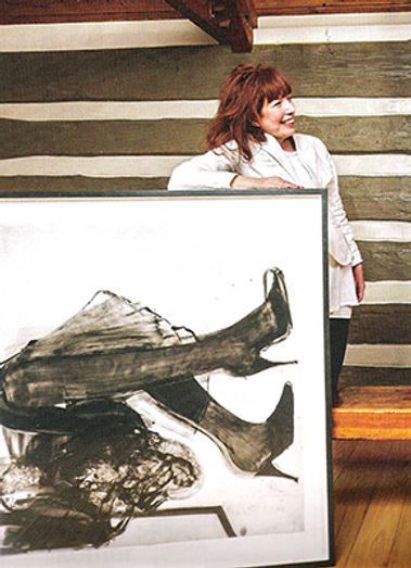 Cathy Daley poses with one of her drawings, photo credit Christopher Dew