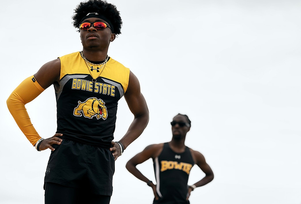 Two Bowie State University track runners catching their breathe