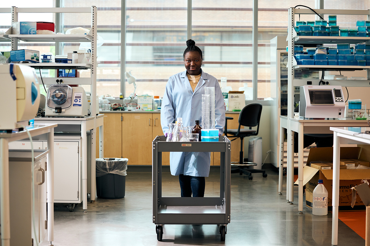 A Bowie State University science student pushing a cart during class