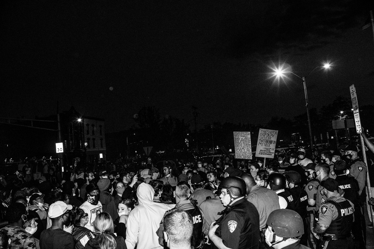 Policemen in riot gear facing off protestors in Asbury Park, NJ.
