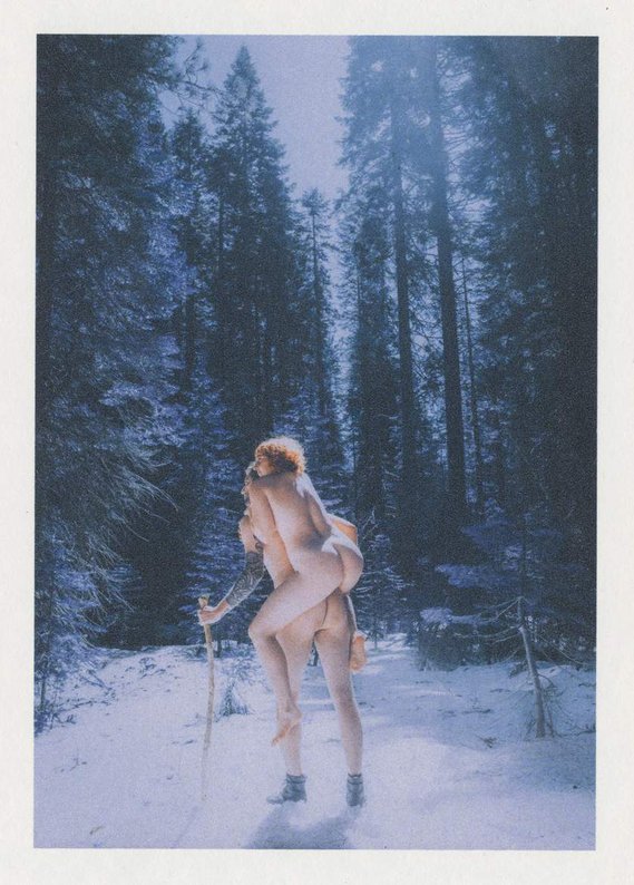Vintage film nude photograph of couple standing in snow in winter landscape at Yosemite National Park