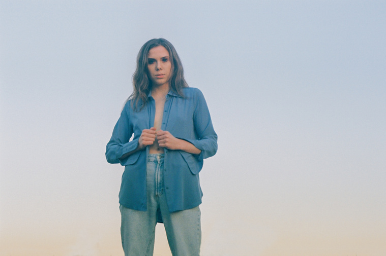 Film portrait of Maren Hill, musician, wearing blue shirt at sunset in Los Angeles, California