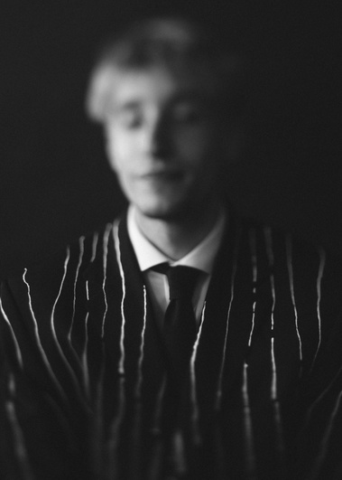 Black and white portrait of man wearing pinstripe suit