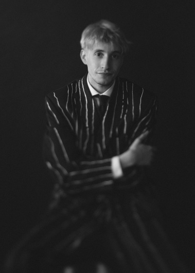 Black and white portrait of man wearing pinstripe suit