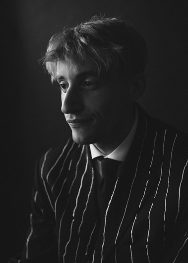 Black and white portrait of man wearing pinstripe suit