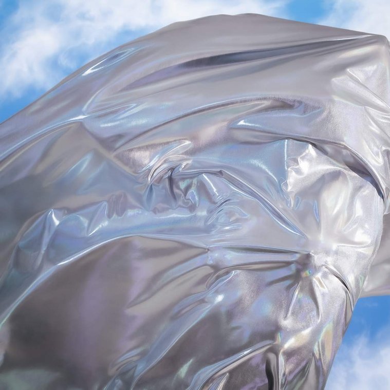 Abstract cover album art for New Zealand band Sachi, silver fabric on body against blue cloudy sky