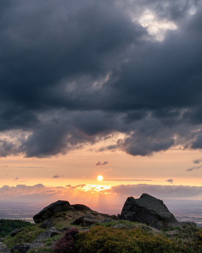 The sun sets beyond the Wainstones on the Cleveland Way. A photography by Tim Pearson.