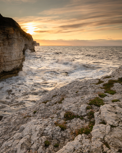 The sun sets above the cliffs and sea, looking towards Bempton, East Yorkshire. A photograph by Tim Pearson.