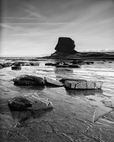 The looming, Sphinx-like presence of Black Nab in the background of Saltwick Bay, near Whitby, North Yorkshire, UK. A photograph by Tim Pearson.