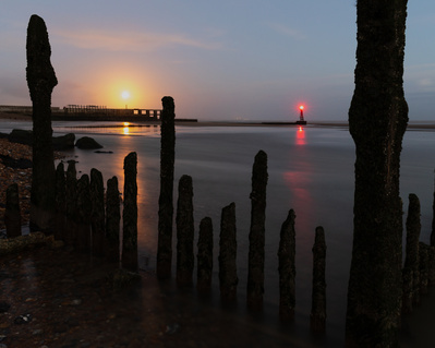 A rising moon over Rye Harbour, Kent. A photograph by Tim Pearson.