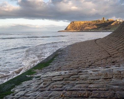 Scarborough Castle in late winter afternoon sunlight; taken from North Bay. A photograph by Tim Pearson.