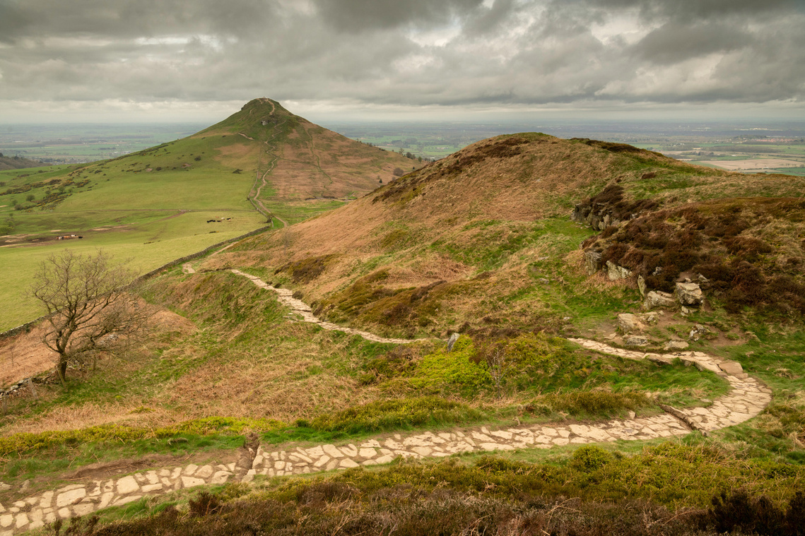 Roseberry Topping, North Yorkshire Moors, under a brooding early spring sky. A photograph by Tim Pearson.