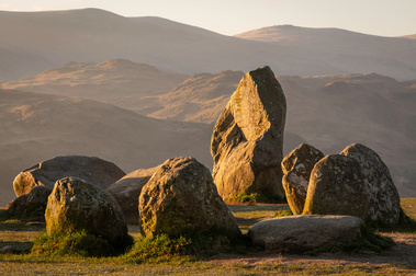 Dawn sunlight on Castlerigg stone circle, Lake District. A photograph by Tim Pearson.