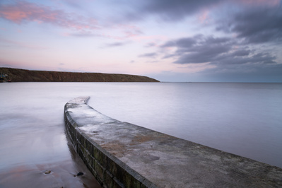 High tide at sunset on the Coble Landing at Filey, North Yorkshire. A photograph by Tim Pearson.