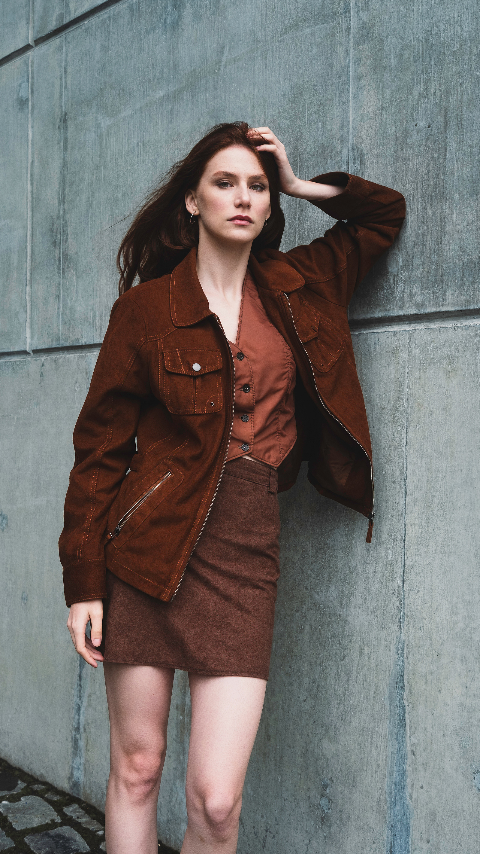 woman leaning on a wall